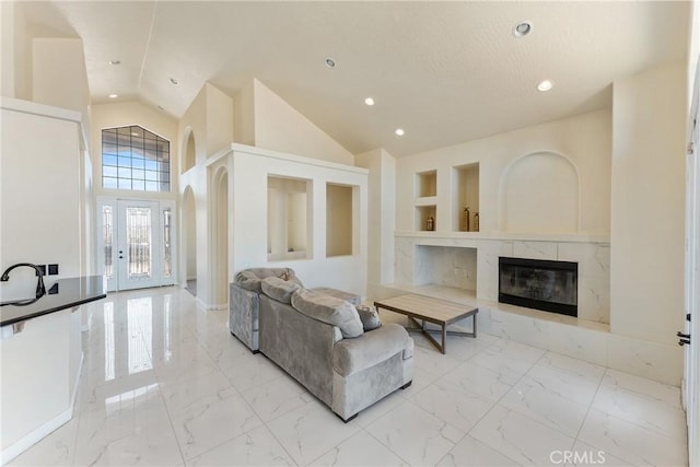 9170 Japatul Rd, Apple Valley, CA 92308 - living room featuring a fireplace, high vaulted ceiling, built in features, marble finish floor, and recessed lighting
