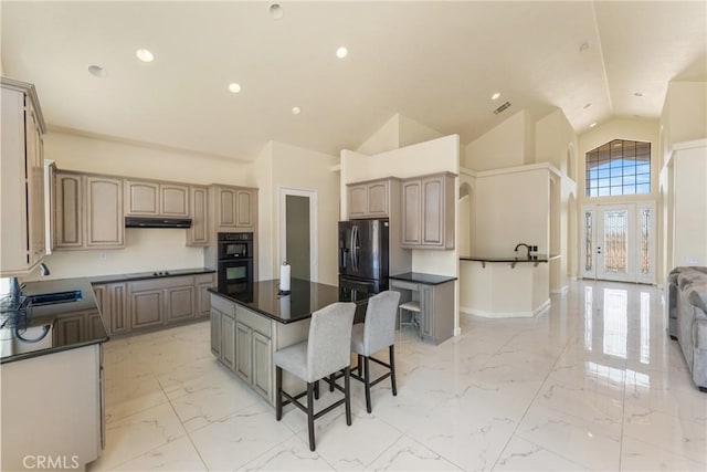 9170 Japatul Rd, Apple Valley, CA 92308 - kitchen featuring marble finish floor, dark countertops, a breakfast bar area, a sink, and black appliances