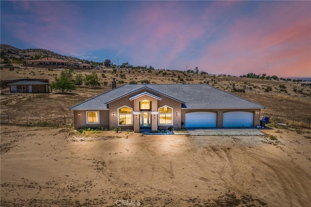 9170 Japatul Rd, Apple Valley, CA 92308 - ranch-style house with fence, a garage, stucco siding, a tiled roof, and driveway