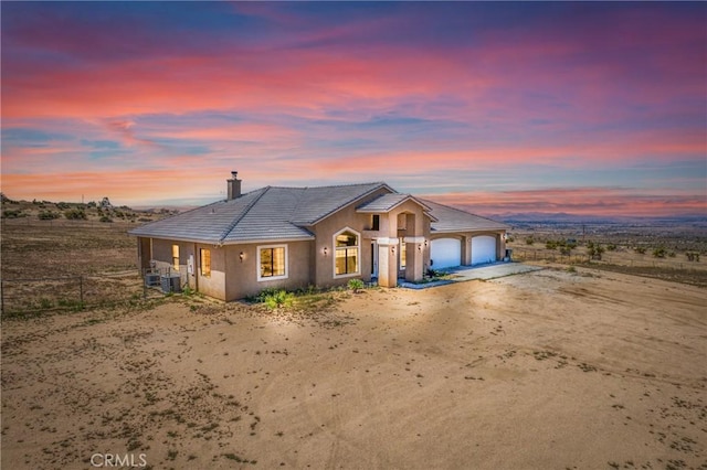 9170 Japatul Rd, Apple Valley, CA 92308 - view of front of house featuring a garage, fence, a chimney, dirt driveway, and a tile roof