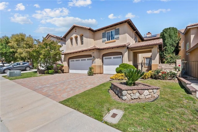 29081 Madrid Pl, Castaic, CA 91384 - mediterranean / spanish-style house featuring an attached garage, a tiled roof, decorative driveway, stucco siding, and roof mounted solar panels