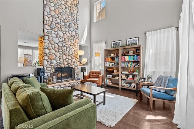 29081 Madrid Pl, Castaic, CA 91384 - living room with a high ceiling, plenty of natural light, a stone fireplace, and wood finished floors