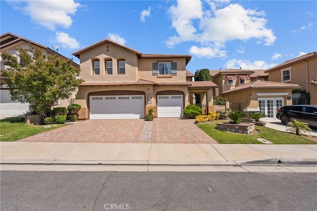 29081 Madrid Pl, Castaic, CA 91384 - mediterranean / spanish home with an attached garage, stucco siding, decorative driveway, a tiled roof, and french doors