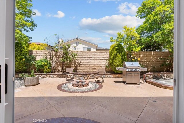 view of patio with grilling area and fence