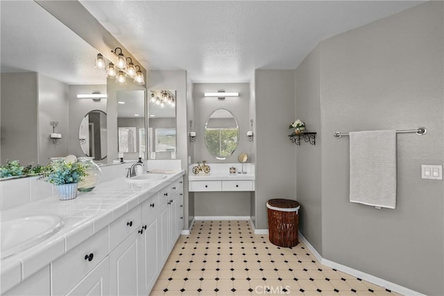 29081 Madrid Pl, Castaic, CA 91384 - bathroom featuring double vanity, baseboards, tile patterned floors, and a textured ceiling