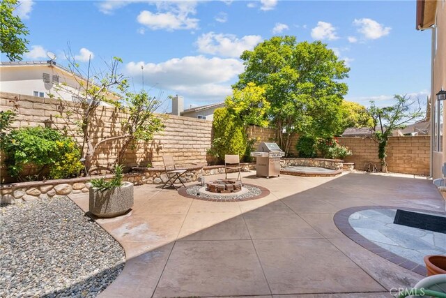 view of patio / terrace with a fenced backyard and a fire pit