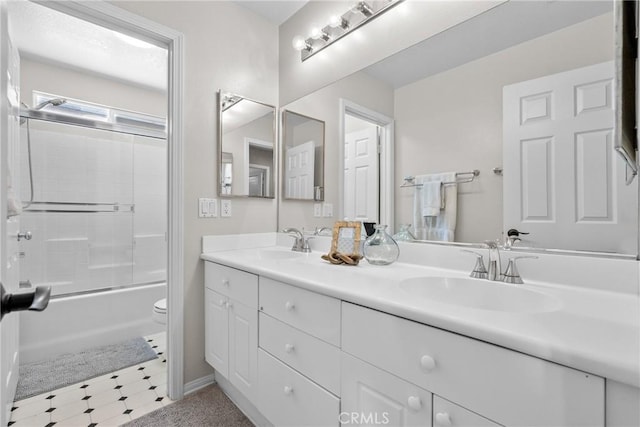 29081 Madrid Pl, Castaic, CA 91384 - full bathroom featuring double vanity, toilet, bath / shower combo with glass door, tile patterned floors, and baseboards