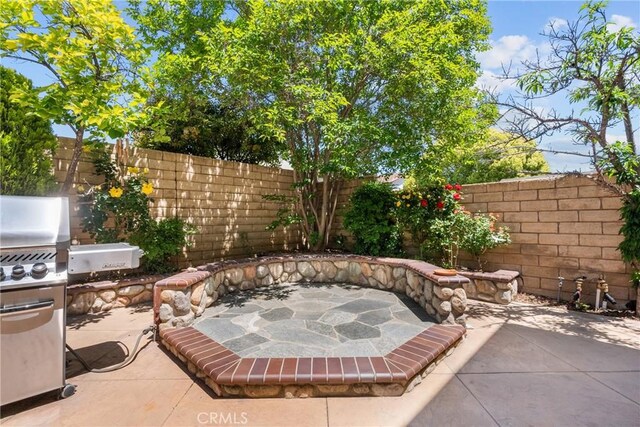 view of patio / terrace featuring a fenced backyard and a grill