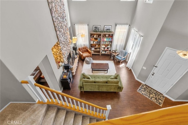29081 Madrid Pl, Castaic, CA 91384 - living room with a high ceiling, baseboards, wood finished floors, a fireplace, and stairs