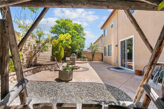 view of patio with a fenced backyard and a grill