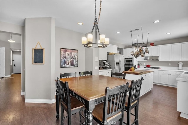 29081 Madrid Pl, Castaic, CA 91384 - dining space with dark wood finished floors, a chandelier, baseboards, and recessed lighting