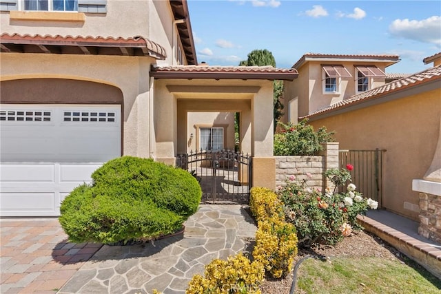 29081 Madrid Pl, Castaic, CA 91384 - doorway to property with stucco siding, a garage, a gate, and a tiled roof