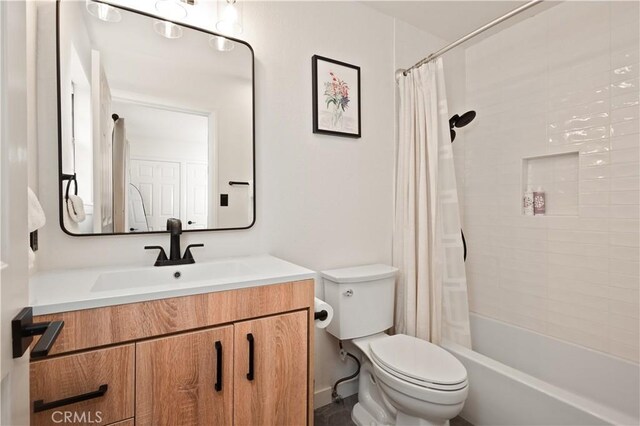 full bath with vanity, shower / tub combo, and toilet