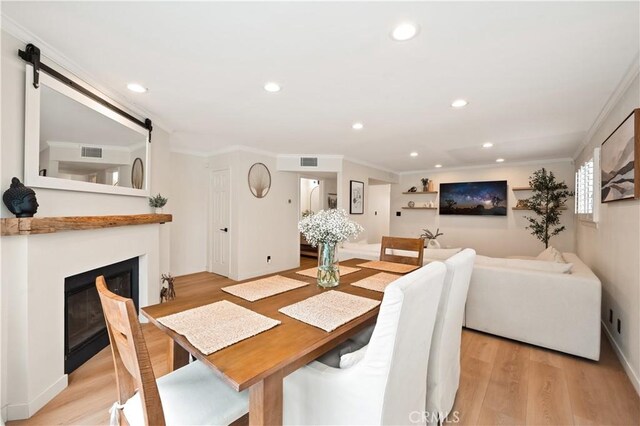 dining area featuring recessed lighting, ornamental molding, light wood finished floors, and visible vents