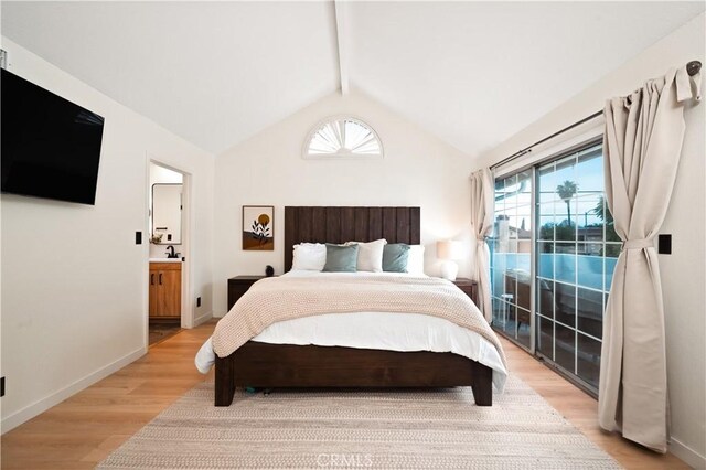 bedroom featuring access to exterior, light wood-style floors, baseboards, vaulted ceiling with beams, and connected bathroom