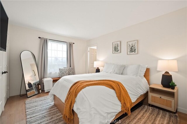 bedroom featuring wood finished floors