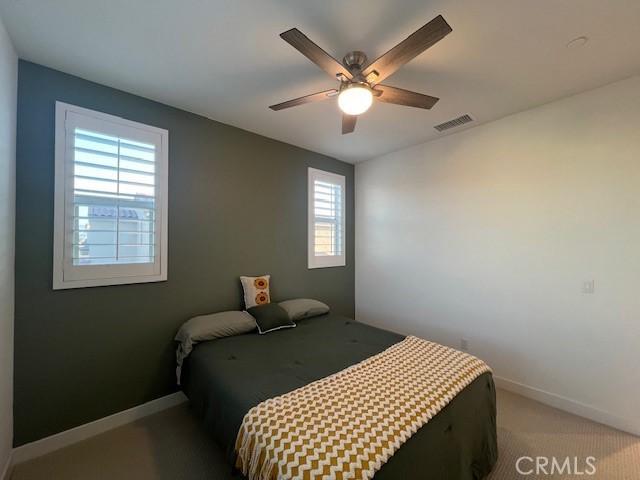 35719 Mccarthy St, Palm Desert, CA 92211 - carpeted bedroom with baseboards, a ceiling fan, and visible vents