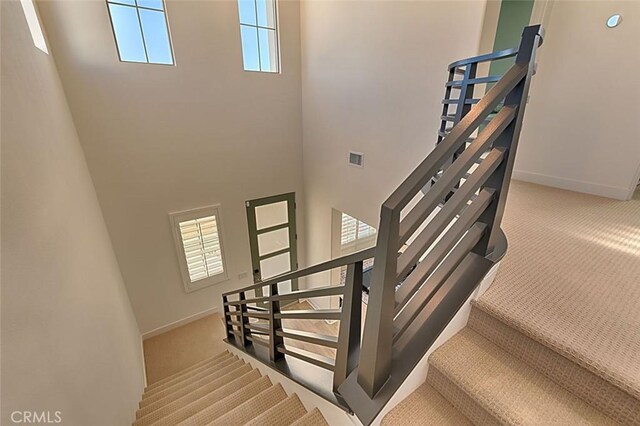 35719 Mccarthy St, Palm Desert, CA 92211 - staircase featuring carpet floors, a high ceiling, visible vents, and baseboards
