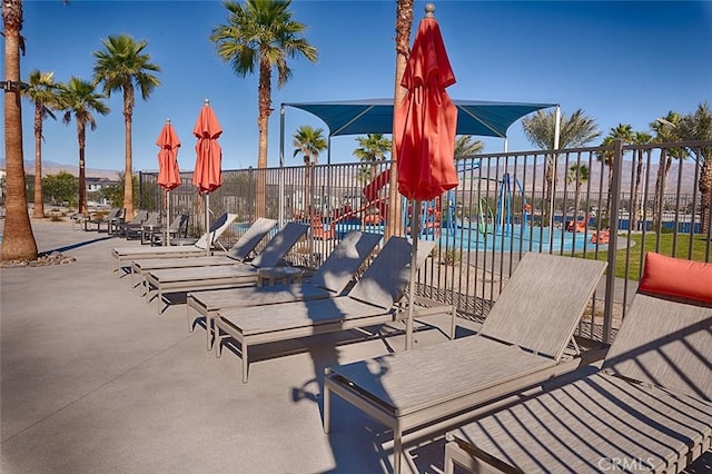35719 Mccarthy St, Palm Desert, CA 92211 - view of patio / terrace featuring fence and a community pool
