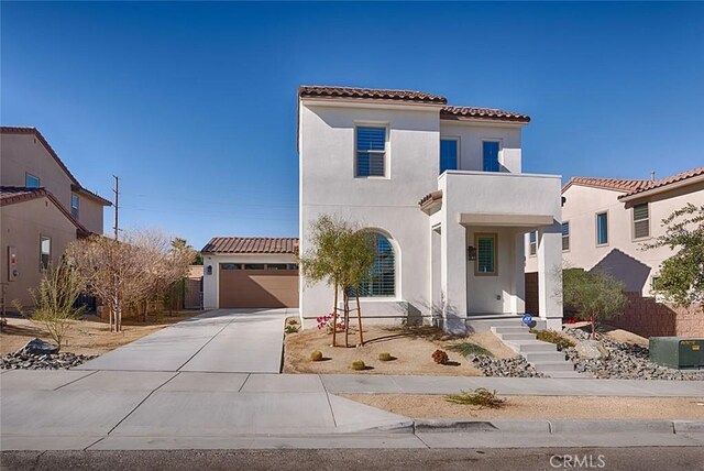 35719 Mccarthy St, Palm Desert, CA 92211 - mediterranean / spanish house with a garage, stucco siding, driveway, and a tile roof