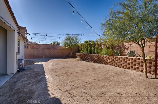 35719 Mccarthy St, Palm Desert, CA 92211 - view of yard featuring a fenced backyard, a patio, and cooling unit