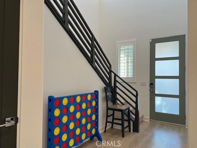 35719 Mccarthy St, Palm Desert, CA 92211 - foyer entrance featuring stairs, baseboards, wood finished floors, and a towering ceiling