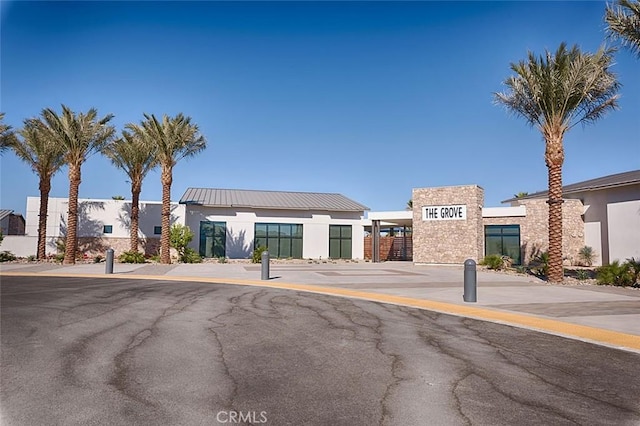 35719 Mccarthy St, Palm Desert, CA 92211 - view of front facade with stucco siding, metal roof, and stone siding