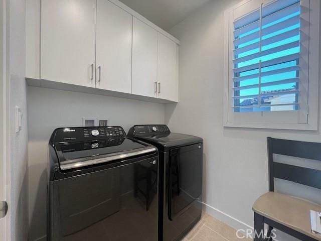35719 Mccarthy St, Palm Desert, CA 92211 - laundry area with light tile patterned floors, baseboards, cabinet space, and independent washer and dryer