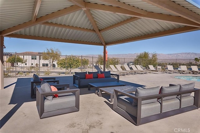35719 Mccarthy St, Palm Desert, CA 92211 - view of patio / terrace featuring an outdoor living space, a community pool, a mountain view, and fence