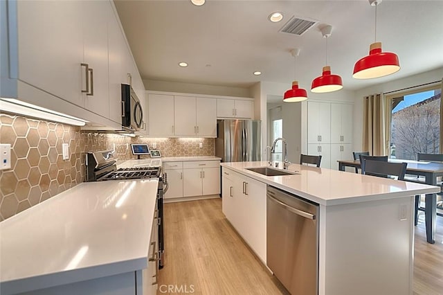 35719 Mccarthy St, Palm Desert, CA 92211 - kitchen with visible vents, recessed lighting, light wood-type flooring, a sink, and appliances with stainless steel finishes