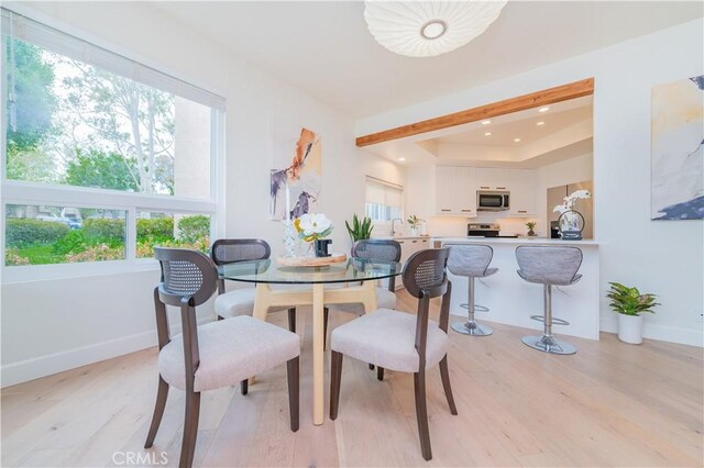 dining area with recessed lighting, baseboards, and light wood-style flooring