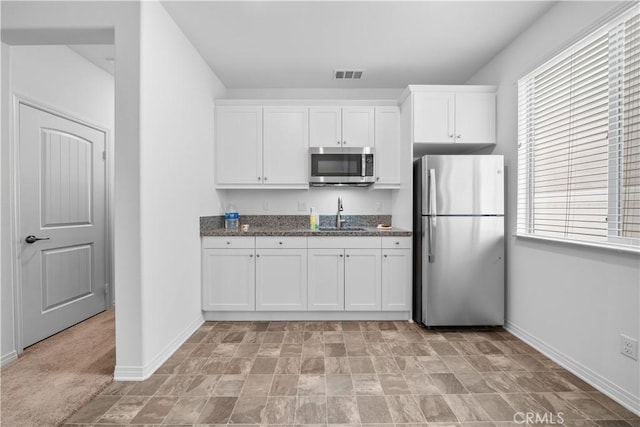 6506 Zion Way, Jurupa Valley, CA 92509 - kitchen with appliances with stainless steel finishes, baseboards, and plenty of natural light