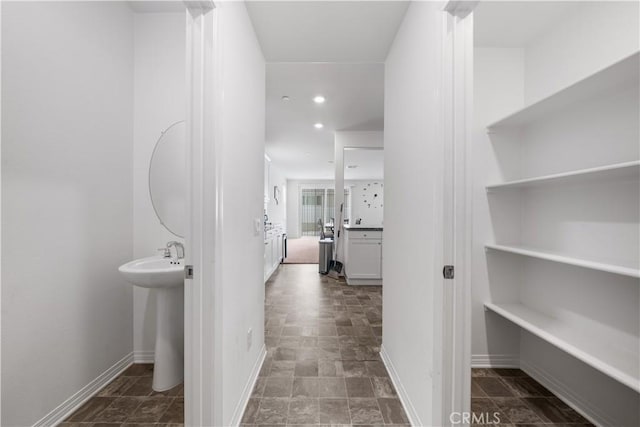 6506 Zion Way, Jurupa Valley, CA 92509 - hall featuring baseboards, recessed lighting, stone finish floors, and a sink