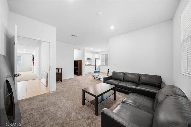 6506 Zion Way, Jurupa Valley, CA 92509 - tiled living area with carpet flooring, recessed lighting, and healthy amount of natural light