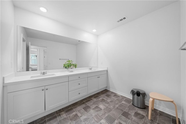 6506 Zion Way, Jurupa Valley, CA 92509 - bathroom with baseboards, double vanity, stone finish flooring, and recessed lighting