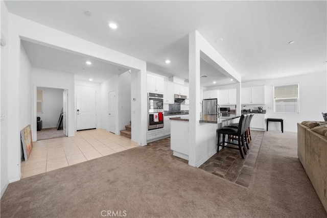 6506 Zion Way, Jurupa Valley, CA 92509 - kitchen featuring light colored carpet, appliances with stainless steel finishes, open floor plan, white cabinetry, and recessed lighting