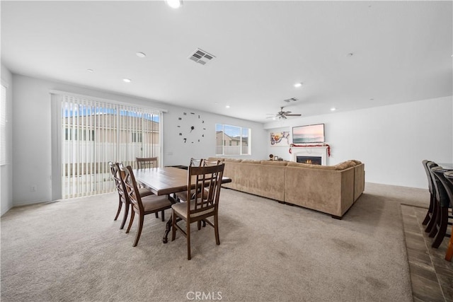 6506 Zion Way, Jurupa Valley, CA 92509 - dining area with light carpet, recessed lighting, a warm lit fireplace, and a ceiling fan