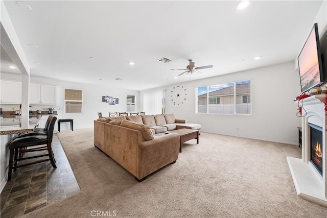 6506 Zion Way, Jurupa Valley, CA 92509 - carpeted living room featuring a lit fireplace, recessed lighting, and a ceiling fan