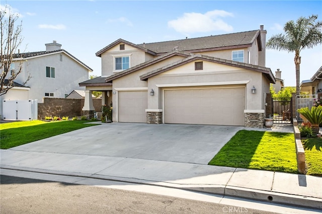 6347 Lyndsey St, Eastvale, CA 92880 - view of front facade with fence, a front lawn, stone siding, a gate, and concrete driveway