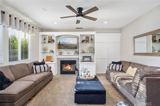 6347 Lyndsey St, Eastvale, CA 92880 - living area with visible vents, a glass covered fireplace, ceiling fan, and light carpet