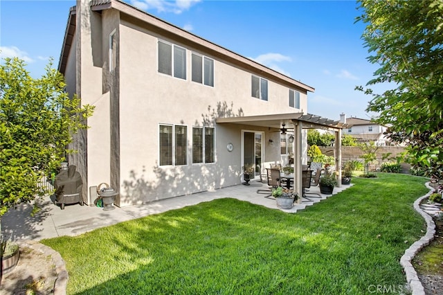 6347 Lyndsey St, Eastvale, CA 92880 - rear view of house featuring fence, stucco siding, a yard, and ceiling fan