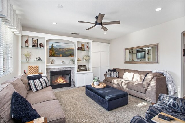 6347 Lyndsey St, Eastvale, CA 92880 - carpeted living area with a glass covered fireplace, ceiling fan, recessed lighting, and visible vents
