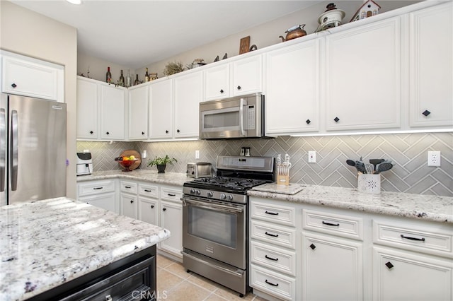6347 Lyndsey St, Eastvale, CA 92880 - kitchen featuring decorative backsplash, white cabinetry, and appliances with stainless steel finishes