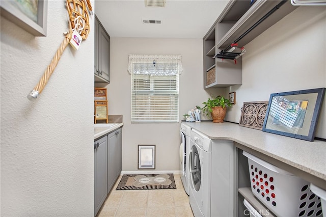 6347 Lyndsey St, Eastvale, CA 92880 - laundry room featuring visible vents, light tile patterned flooring, baseboards, cabinet space, and independent washer and dryer