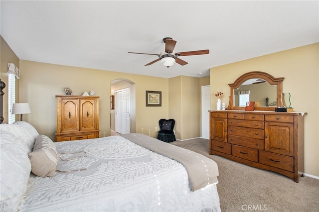 6347 Lyndsey St, Eastvale, CA 92880 - bedroom featuring arched walkways, a ceiling fan, light carpet, and baseboards