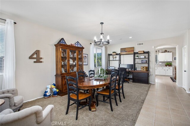 6347 Lyndsey St, Eastvale, CA 92880 - dining space with visible vents, arched walkways, light tile patterned floors, baseboards, and a chandelier