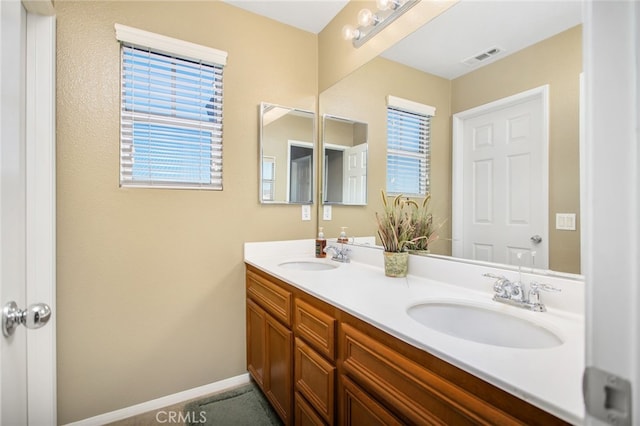 6347 Lyndsey St, Eastvale, CA 92880 - bathroom featuring visible vents, a sink, baseboards, and double vanity