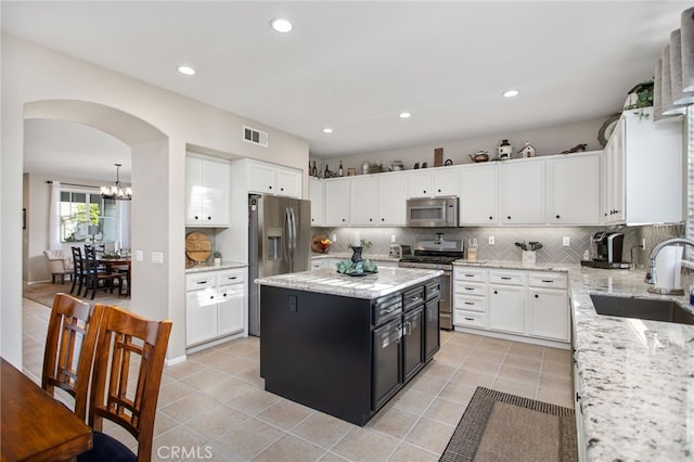 6347 Lyndsey St, Eastvale, CA 92880 - kitchen with a sink, appliances with stainless steel finishes, light tile patterned floors, and white cabinets