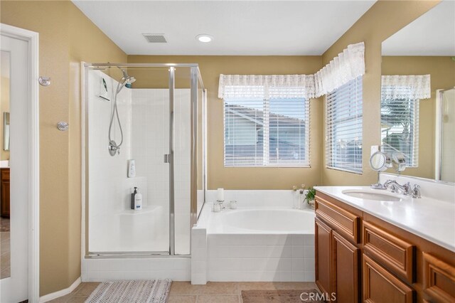 6347 Lyndsey St, Eastvale, CA 92880 - bathroom featuring vanity, tile patterned flooring, a bath, and a stall shower