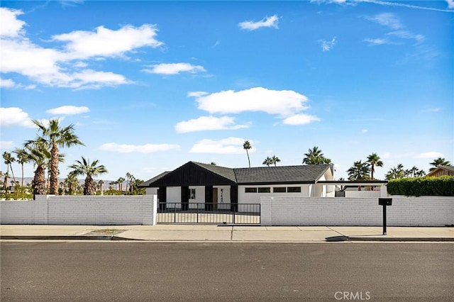 ranch-style home with a gate and a fenced front yard